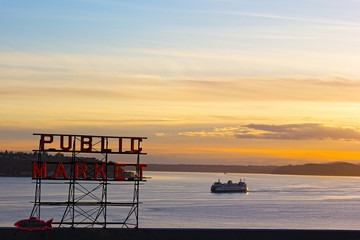 Sunset over Puget Sound in Seattle. Pike Public Market neon sign at sunset. - obrazy, fototapety, plakaty