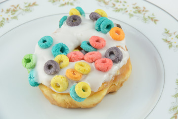 Decadent Doughnut with cereal and icing on plate 