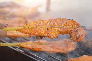 grilled Chicken,Grilled chicken thigh on the flaming grill.