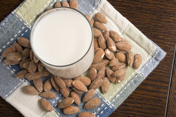Almond Milk with almonds on table - Overhead