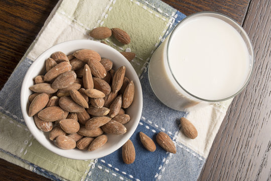 Almond Milk with almonds on table - Overhead