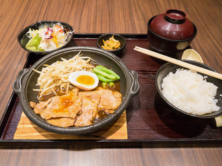 pork with egg and vegetables on hot plate