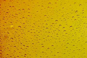 Yellow or gold water drops on background