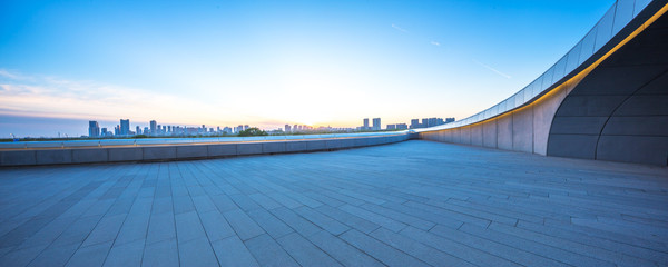 empty square with cityscape and skyline at sunrise in harbin