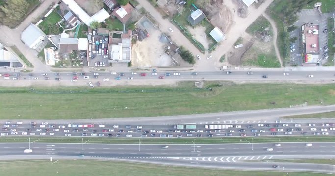 Aerial drone scene of jamed highway. Top view of traffic in the road. City rush hour. Camera moves gently showing the city jam.
