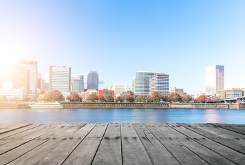 Naklejka premium empty wood floor near water with cityscape and skyline of portla