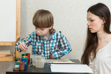 mother with boys son paint colors at home