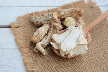 dang gui, angelica sinensis, dang gui ginseng on wooden background, traditional chinese herbal...