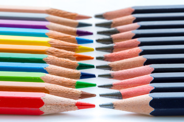 Several colored and black pencils in contrast