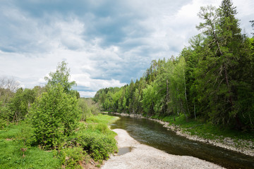Plakat landscape with trees and a river in front