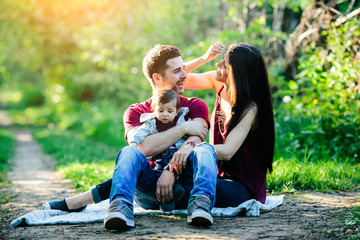 Fototapeta premium young family with a child on the nature