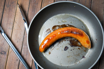 One fried sausage on the skillet