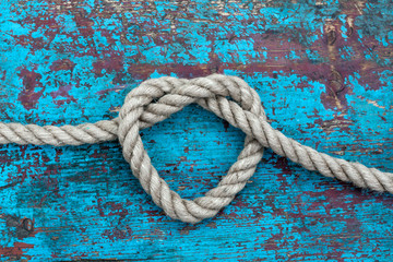 Fototapeta na wymiar Heart from rope on blue background