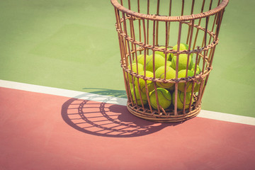 Tennis Ball with Racket on old basket tennis court
