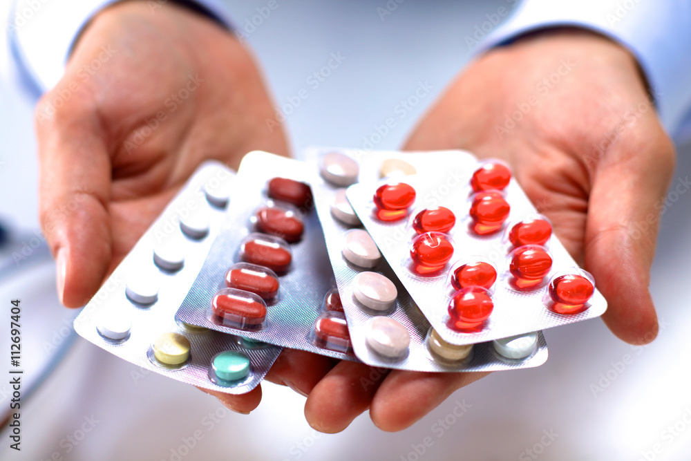 Canvas Prints Hand of doctors holding many different pills