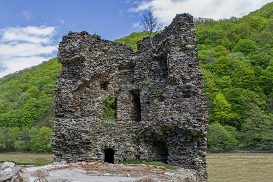Medieval broken tower. The custom-house on Olt river in Carpathian mountains.