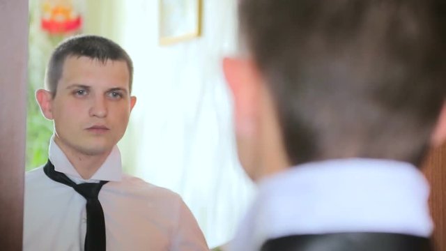 Man Putting On Tie