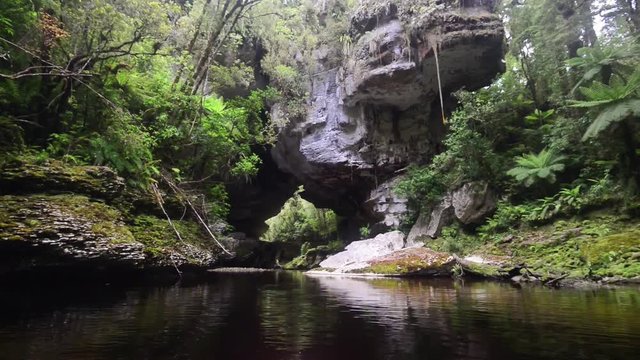 Camera moving slowly into the Honeycomb Hill Arch, New Zealand