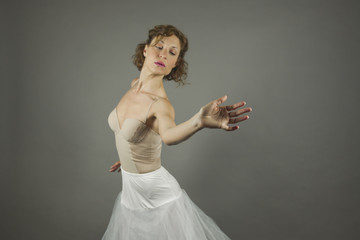 Fototapeta premium Young expressive ballerina with practicing ballet by herself