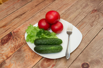 tomatoes and cucumber in a bowl on a table