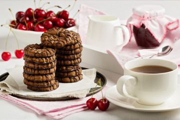 Breakfast. Tea with chocolate chip cookies on a white tray.