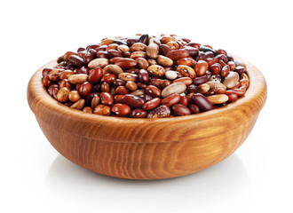 Wooden bowl with beans isolated on white background.