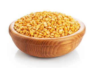 Wooden bowl with peas isolated on white background.