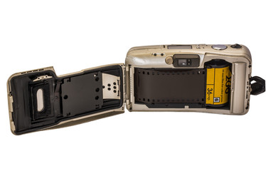 Old camera with photographic film isolated on white background