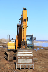 Obraz premium excavator on the river bank