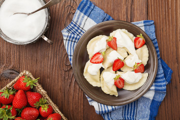 Delicious dumplings with fresh strawberries served with whipped