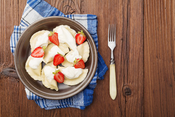 Delicious dumplings with fresh strawberries served with whipped
