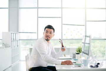 Asian entrepreneur working in big light office