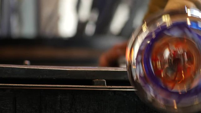Glassworks glass manufacturing process - glass rolling on the marver