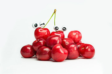 Ripe red сherries with different emotions isolated on white background