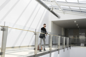 Elegant man in sunglasses on balcony