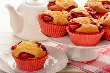 Strawberry muffins on the white plate. 