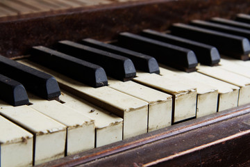 Fototapeta na wymiar Old broken disused piano with damaged keys
