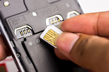 Hand put sim card to the sim card tray