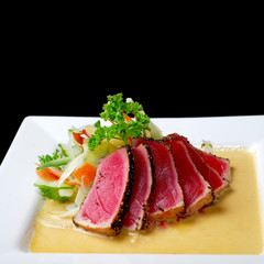 Premium raw japanese kobe beef sliced on plate with black pepper