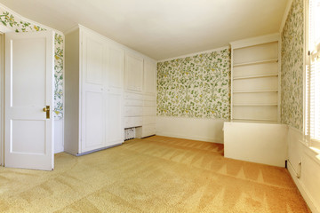 Adorable light bedroom with floral patterned wall paper and carp