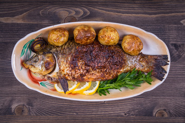 Fried fish carp on the plate