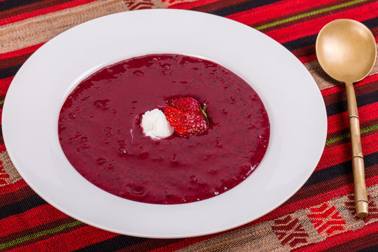 Blueberry strawberry soup with fruit and ice cream