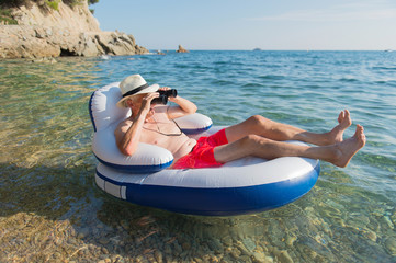 Senior man floating in sea