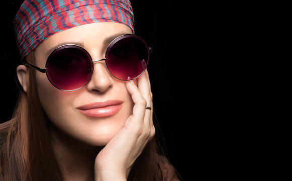 Gorgeous young woman in a head scarf and sunglasses