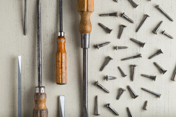 Accessory, assorted tools set on wooden light background. Construction assortment instruments for repairman, carpenter, builder. Copy space for text. Top view. 