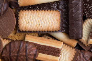 Cookies assorted on black background. Delicious morning snacks for breakfast, brunch and lunch. Appetizing, sweet and fast food.