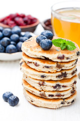 Stack  of welsh cakes with blueberry and a cup of green tea