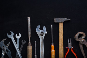 Accessory, assorted tools set on dark background. Construction assortment instruments for repairman, carpenter, builder. Copy space for text. Top view. 