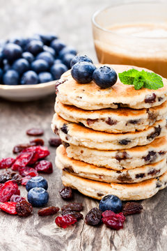 Stack  of welsh cakes with blueberry and a cup of coffee