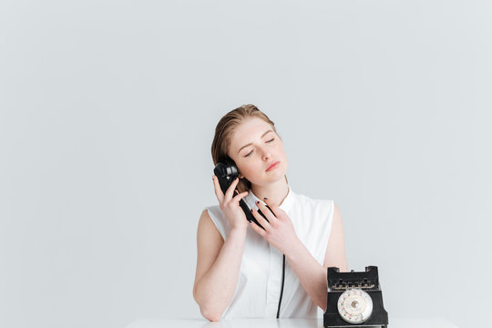 Relaxed Woman With Closed Eyes Speaking On Retro Phone